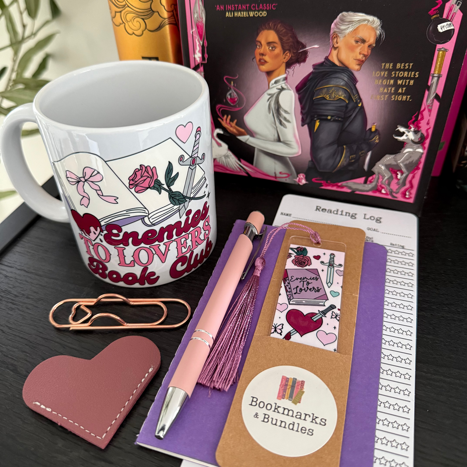 Book-themed stationery items including a mug, pen, bookmarks, notepad